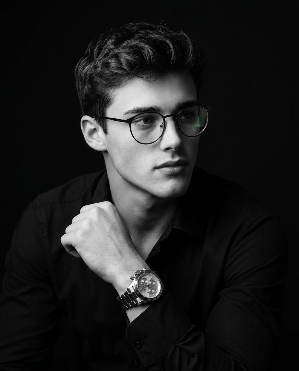 Black-and-white studio portrait of a man in a suit, an AI photo editing prompt result